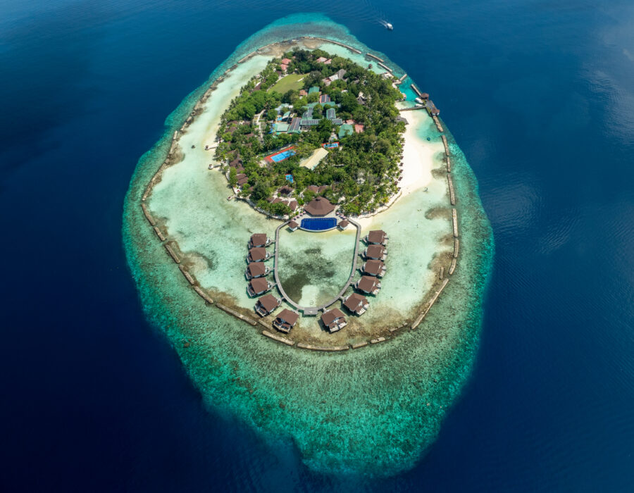 Aerial view of Ellaidhoo Maldives by Cinnamon and its house reef