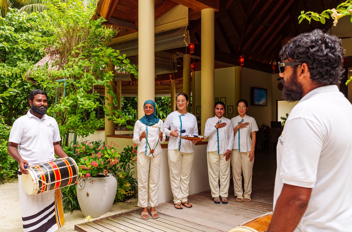 Resort staff welcoming guests at Reethi Faru