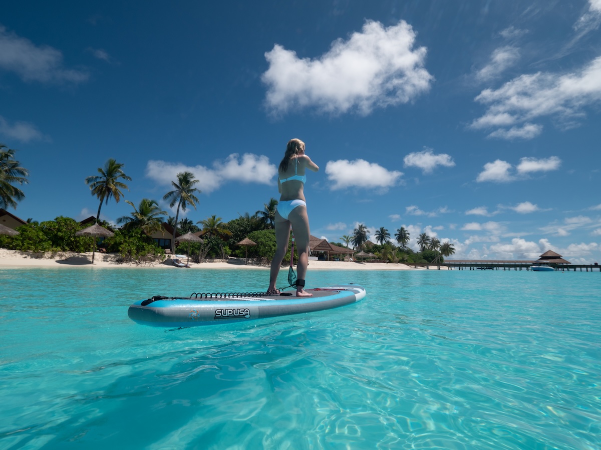 Guest paddleboarding on the clear lagoon