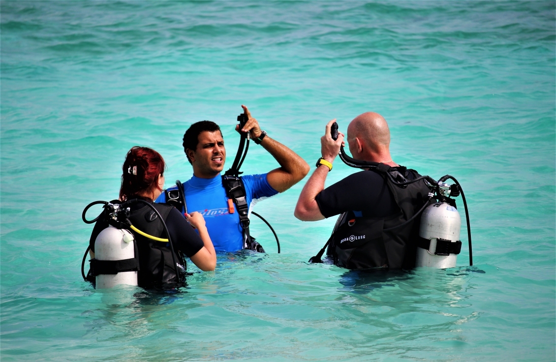 Dive instructor guiding guests through their first scuba experience