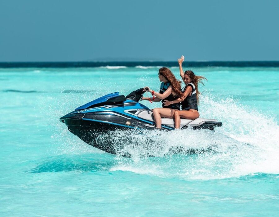 Guests riding jet skis across the turquoise lagoon